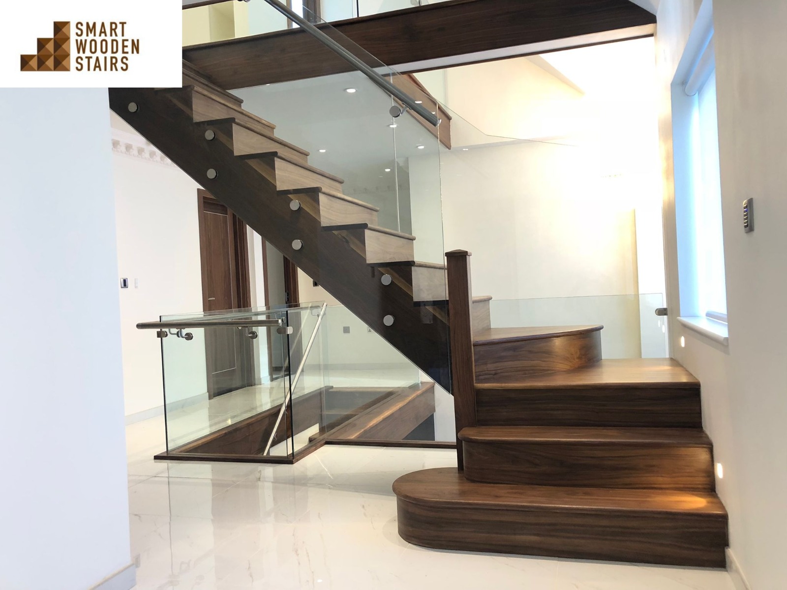 Walnut cut-string staircase with glass