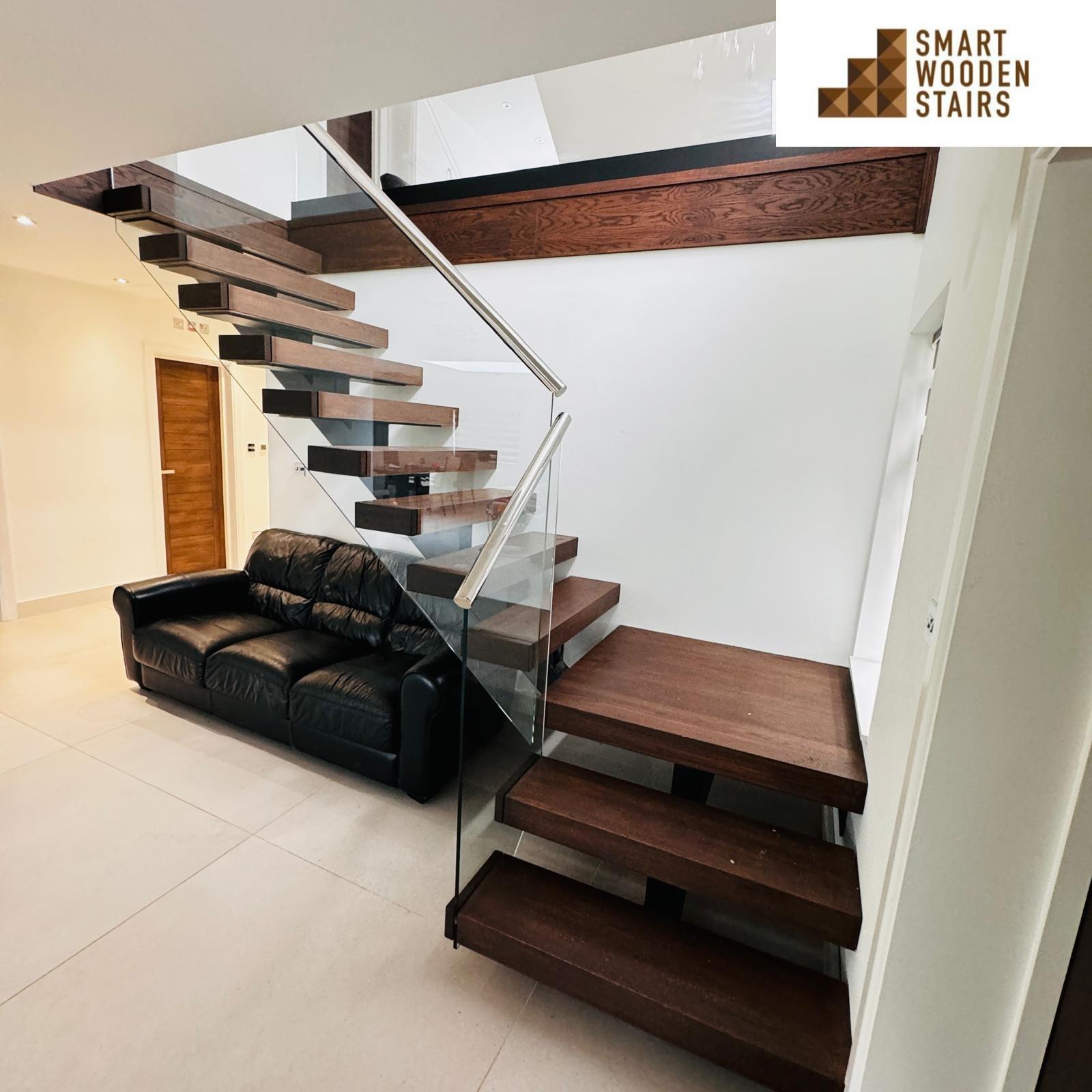 Oak floating staircase with walnut finish and chrome handrail and glass